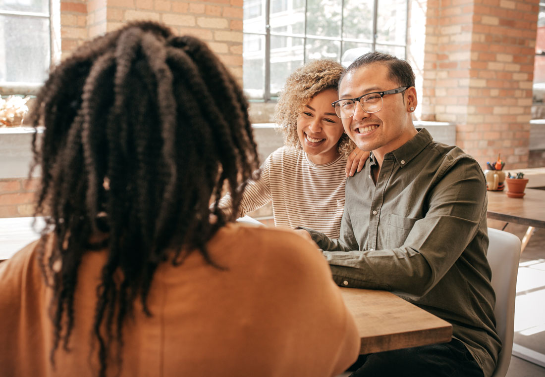 Three people sitting together in discussion